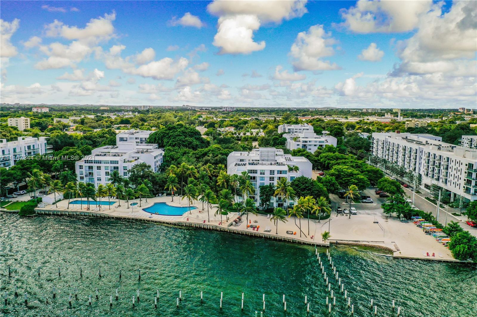 750 Northeast 64th Street, Unit B415 Miami, FL 33138 - Photo 26 of 32 a view of a city with lawn chairs and large trees