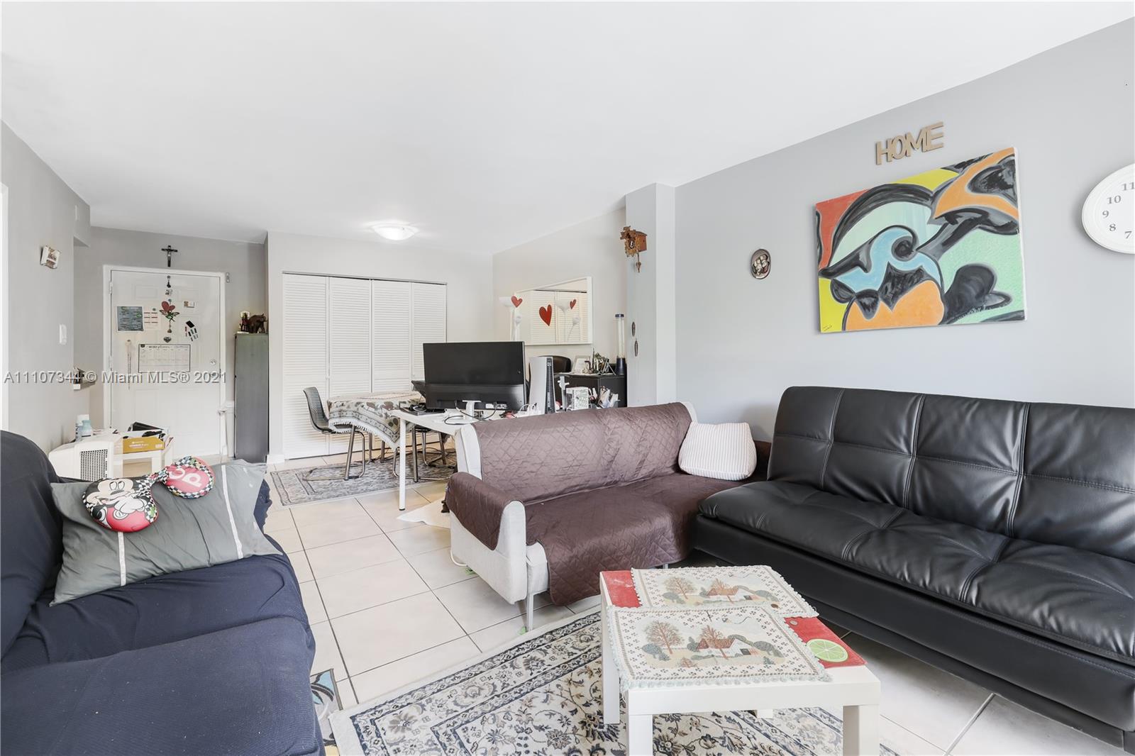 750 Northeast 64th Street, Unit B415 Miami, FL 33138 - Photo 6 of 32 a living room with furniture and a couch