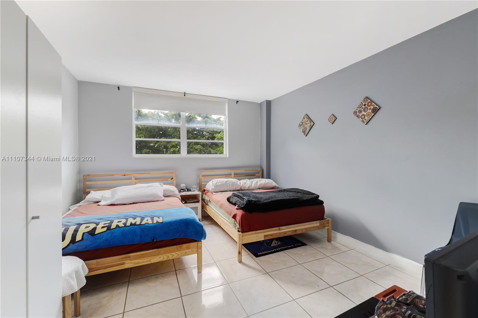 750 Northeast 64th Street, Unit B415 Miami, FL 33138 - Photo 8 of 32 a bedroom with furniture and a window