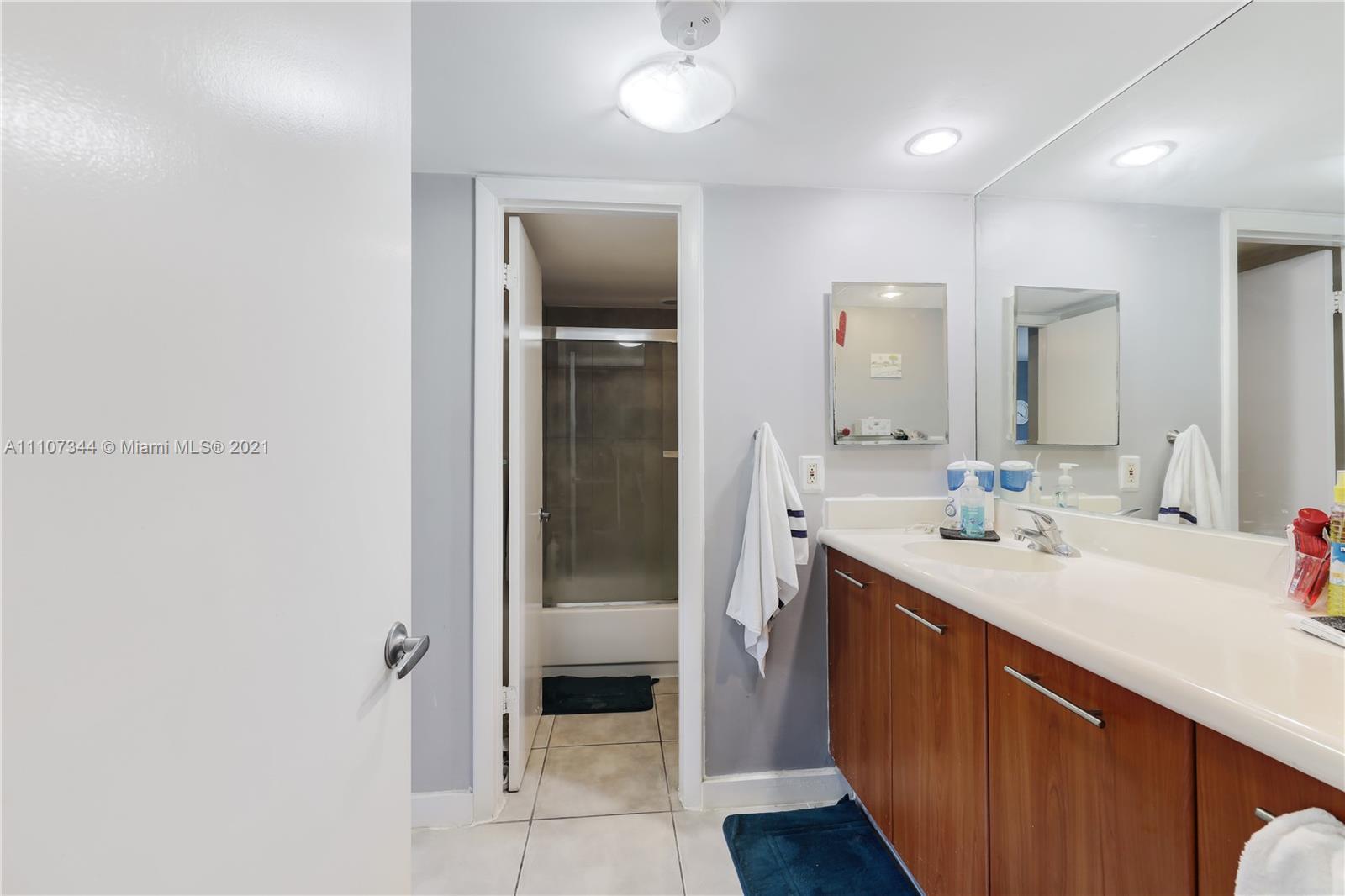750 Northeast 64th Street, Unit B415 Miami, FL 33138 - Photo 10 of 32 a bathroom with a sink and a mirror