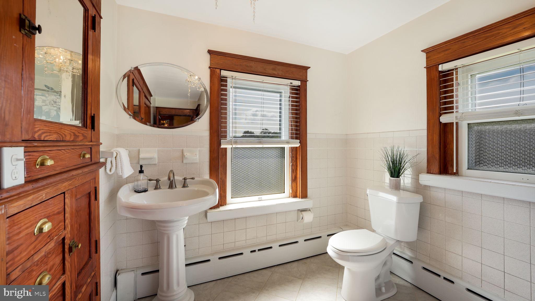 148 South Main Street Dublin, PA 18917 - Photo 15 of 21 a bathroom with a sink toilet and a mirror