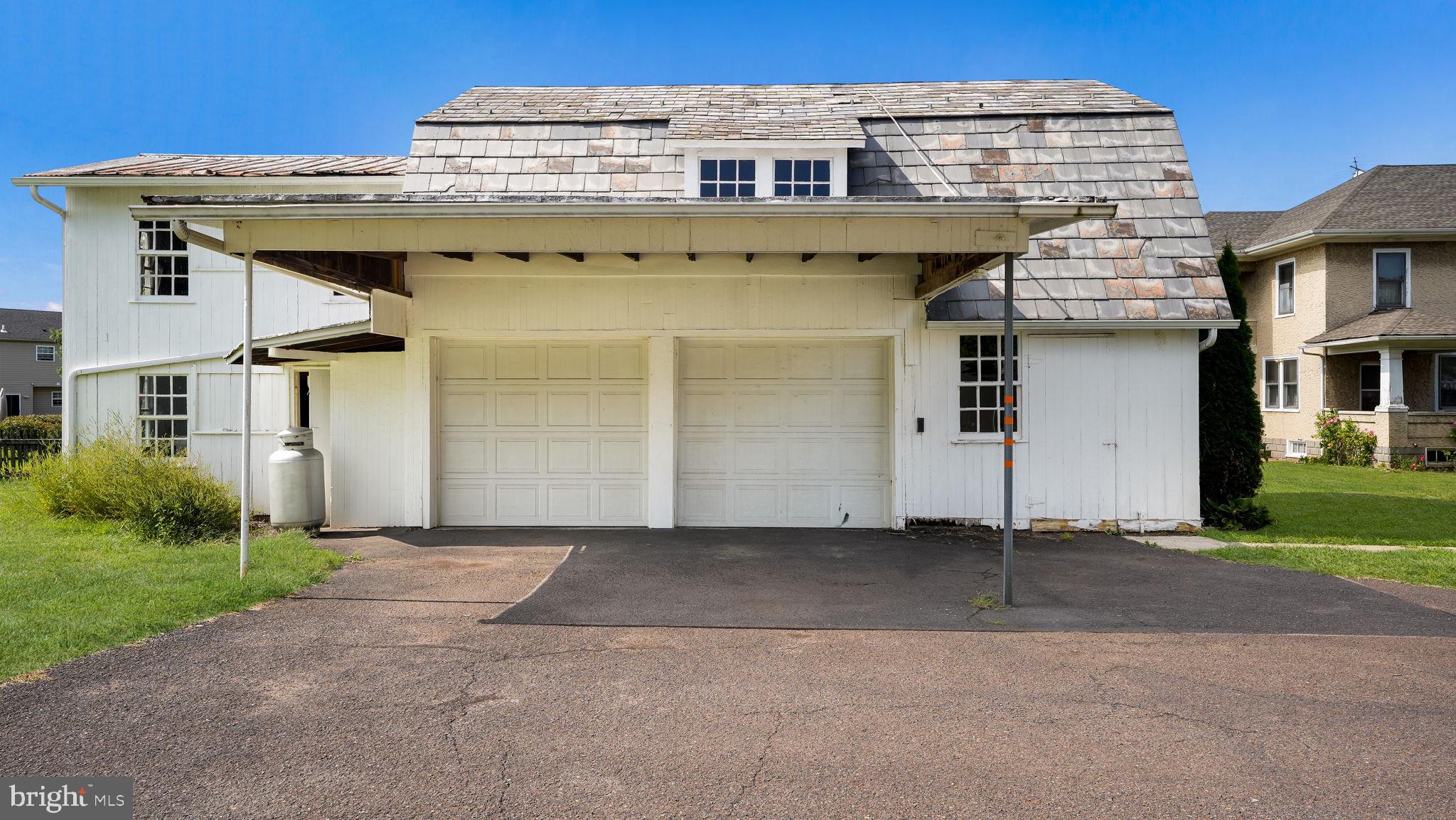 148 South Main Street Dublin, PA 18917 - Photo 18 of 21 a view of a large building with a small yard and plants