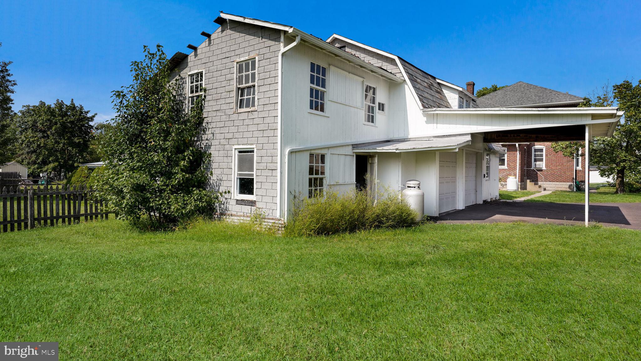 148 South Main Street Dublin, PA 18917 - Photo 19 of 21 a view of a white house with a big yard and potted plants