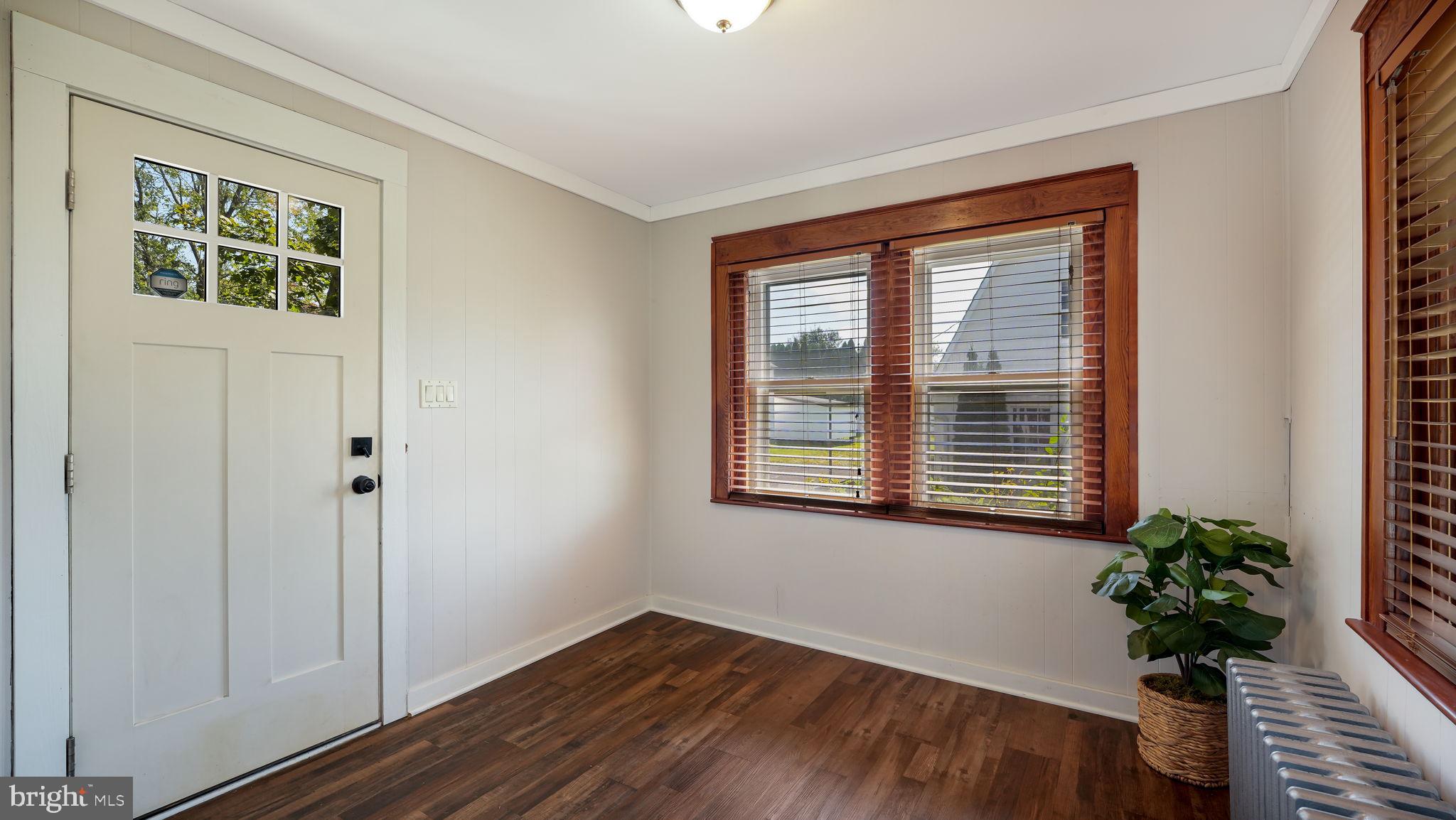 148 South Main Street Dublin, PA 18917 - Photo 2 of 21 a view of an empty room with a window and wooden floor