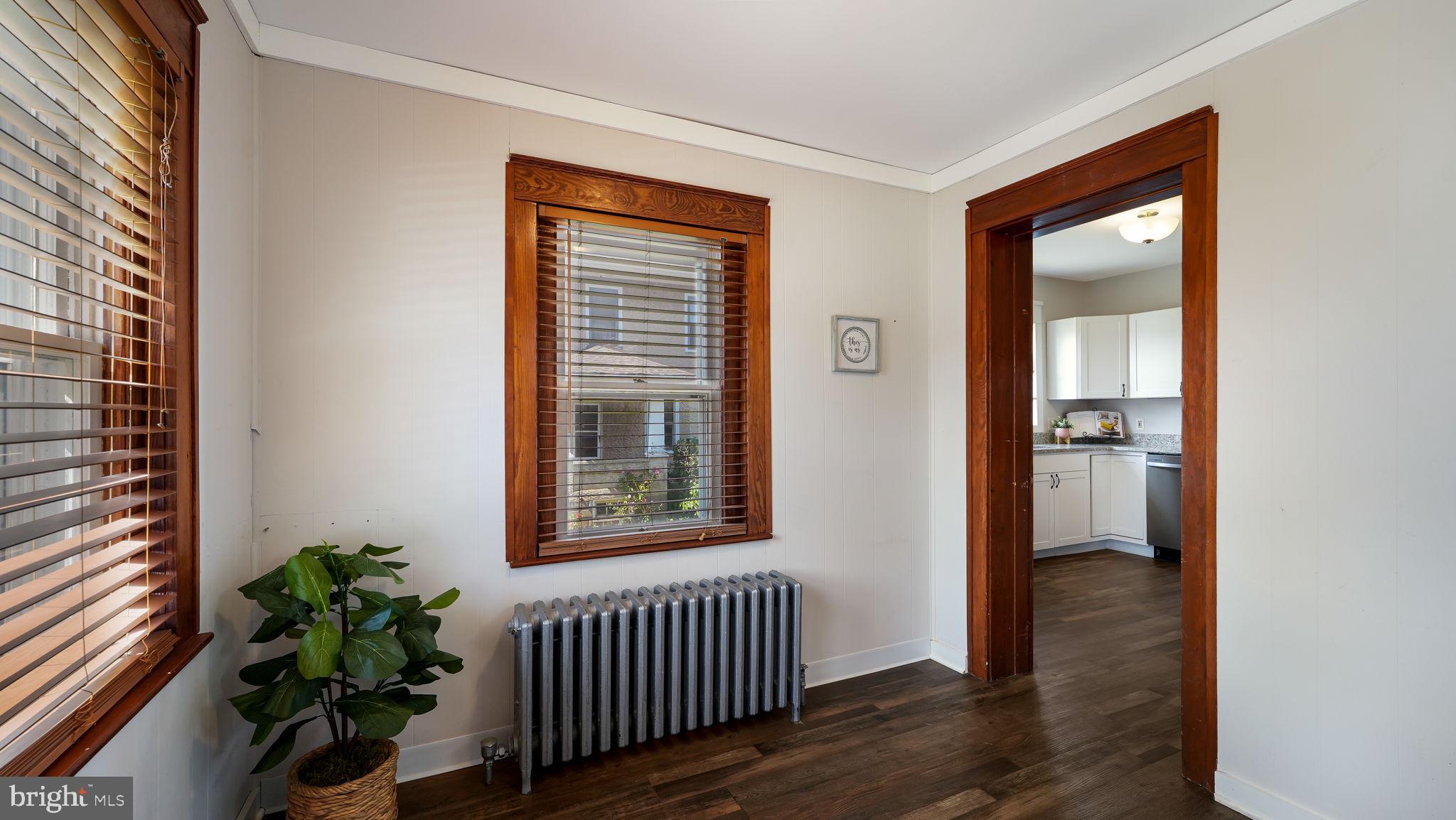 148 South Main Street Dublin, PA 18917 - Photo 3 of 21 an empty room with wooden floor and a window