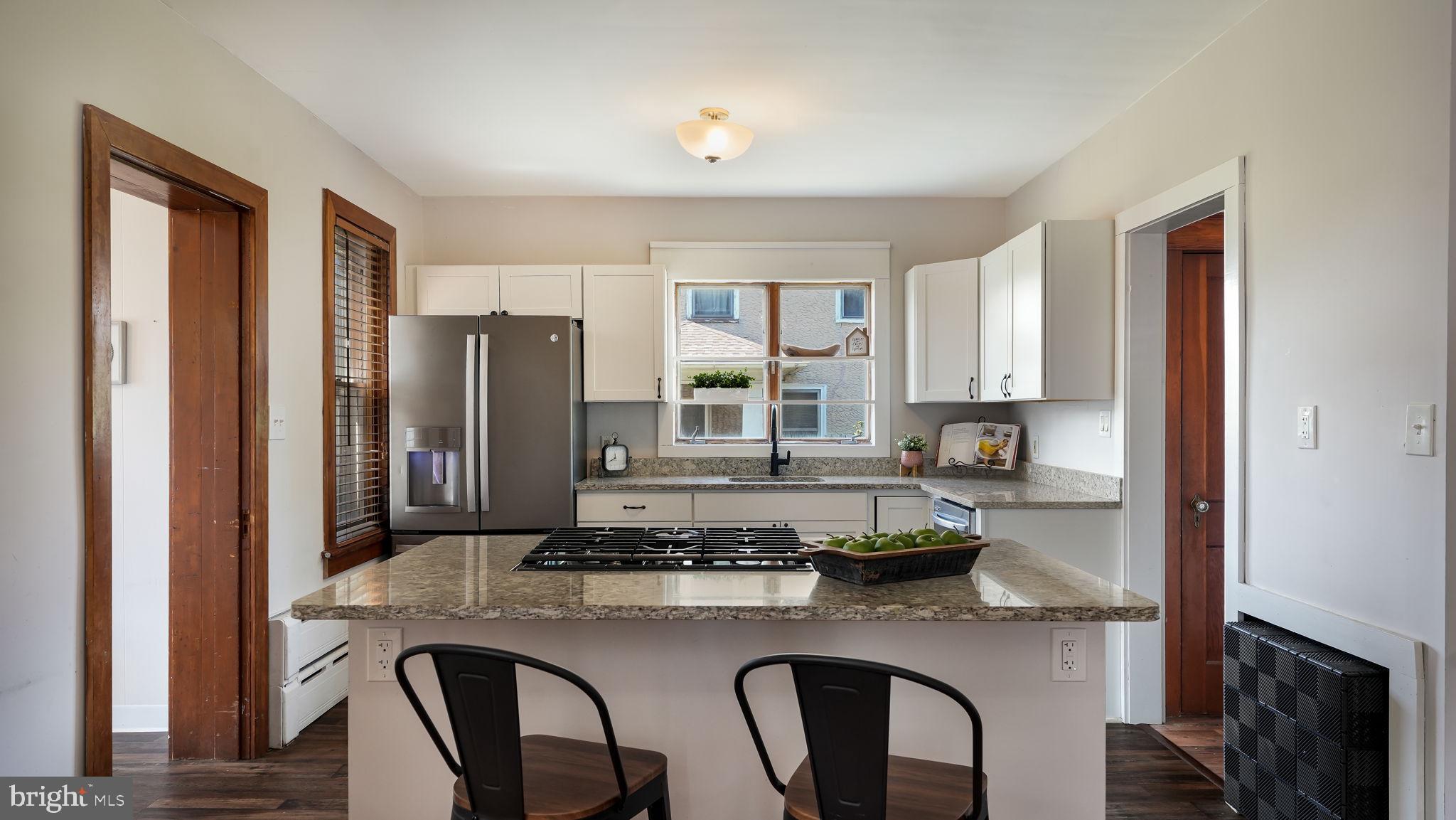 148 South Main Street Dublin, PA 18917 - Photo 5 of 21 a kitchen with sink a refrigerator and chairs