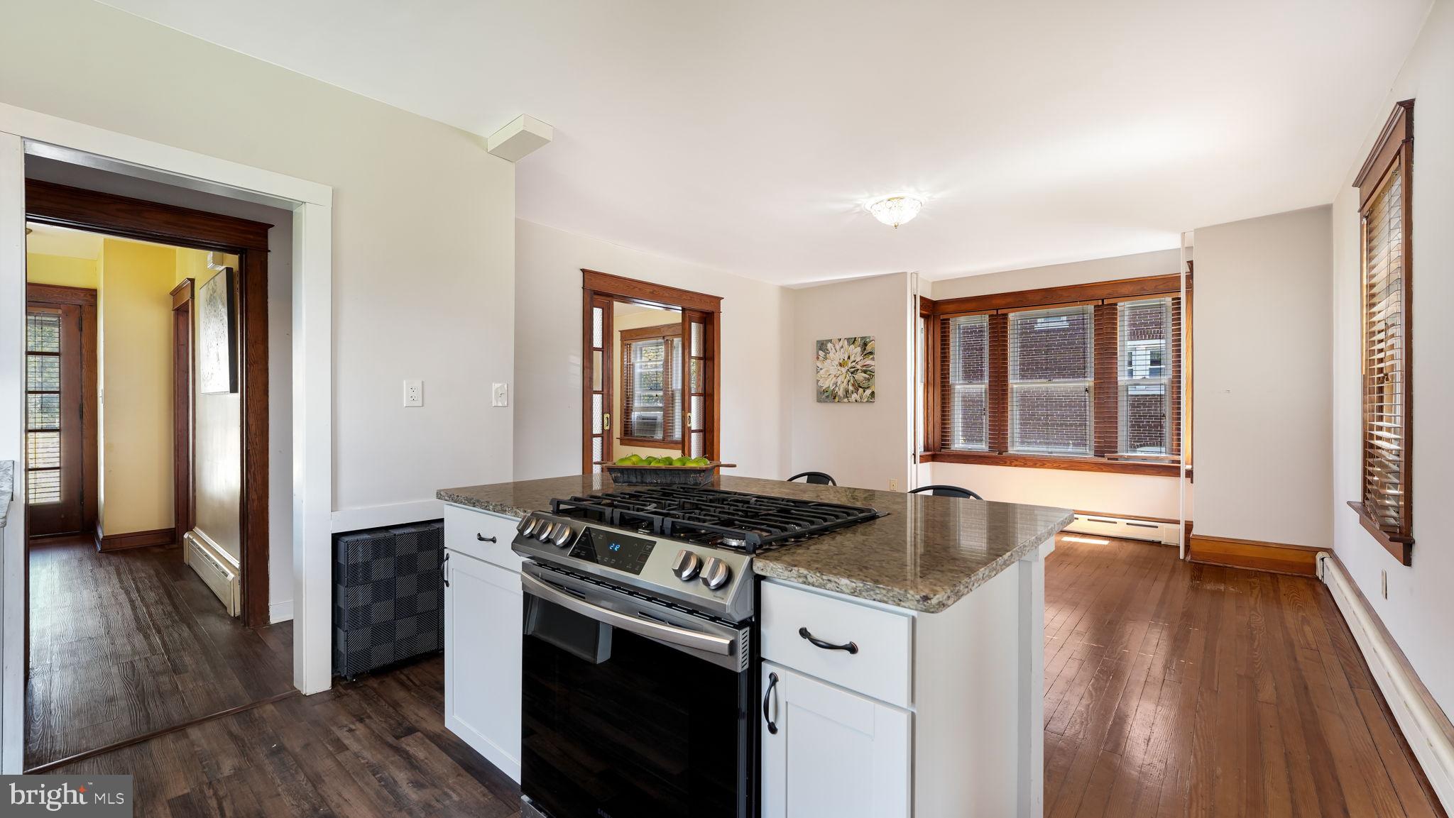 148 South Main Street Dublin, PA 18917 - Photo 6 of 21 a kitchen that has a stove and a wooden floor