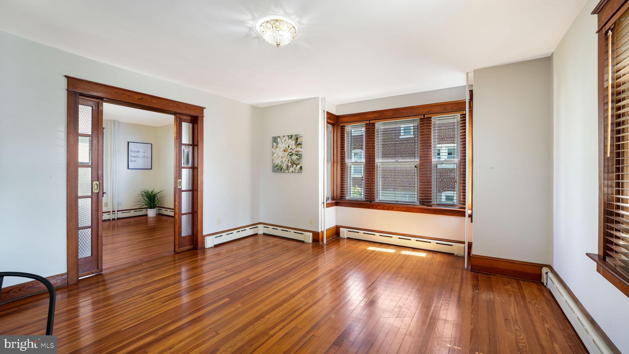 148 South Main Street Dublin, PA 18917 - Photo 7 of 21 a view of an empty room with glass door and wooden floor