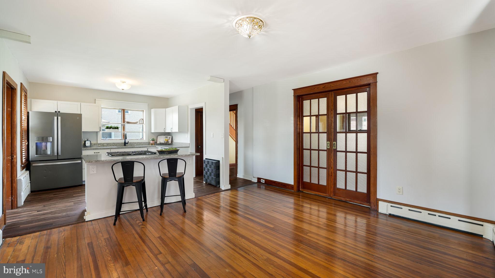 148 South Main Street Dublin, PA 18917 - Photo 8 of 21 a living room with stainless steel appliances kitchen island granite countertop wooden floor and a refrigerator
