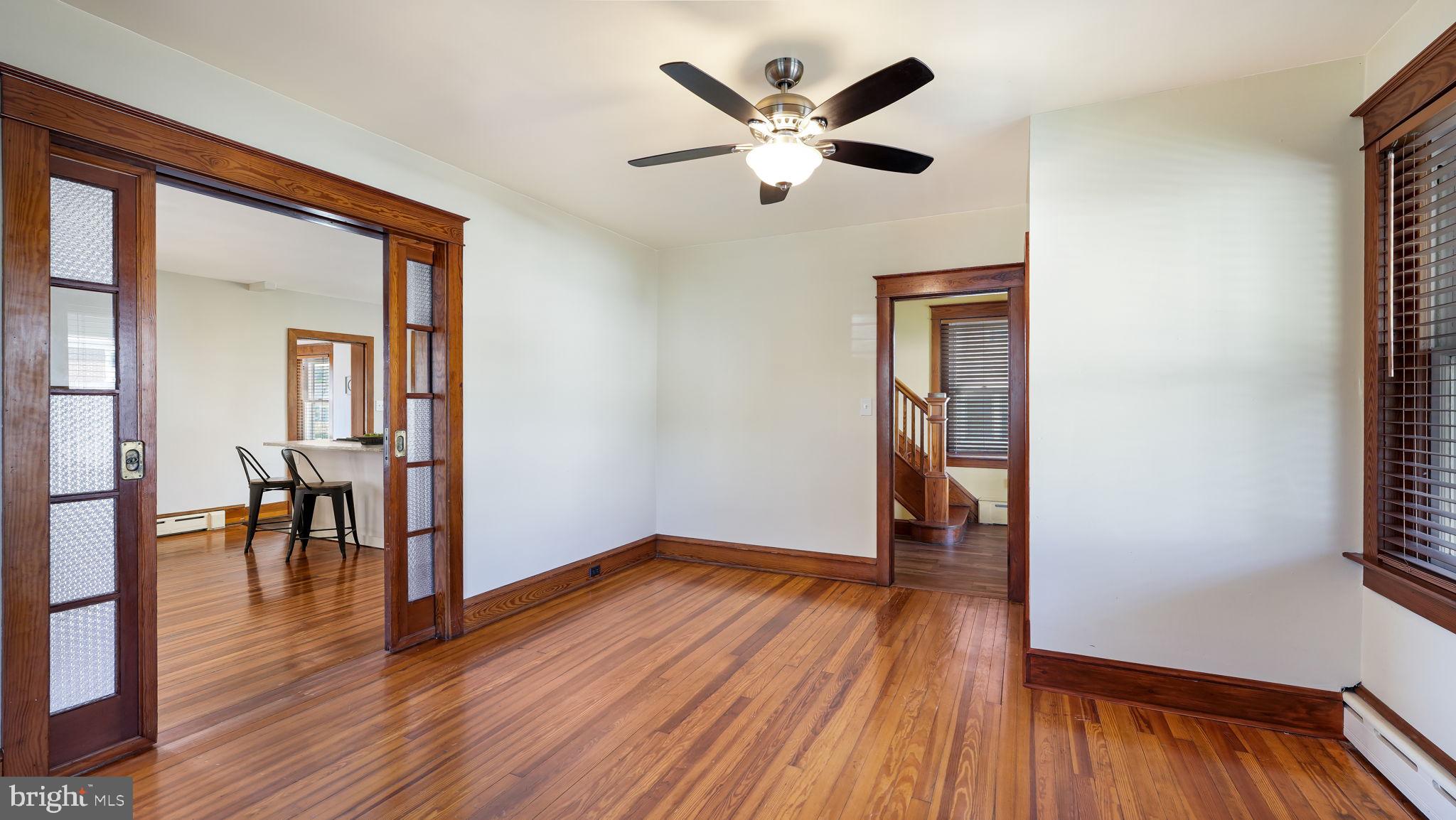 148 South Main Street Dublin, PA 18917 - Photo 9 of 21 an empty room with wooden floor and a ceiling fan