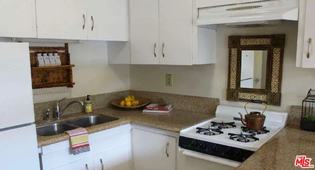 a living room with furniture a rug and a table