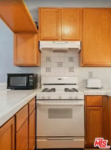 a living room with furniture a fireplace and wooden floor
