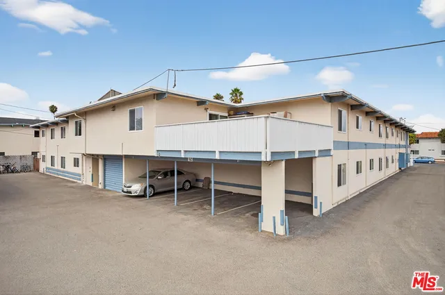 a view of a house with a yard and deck