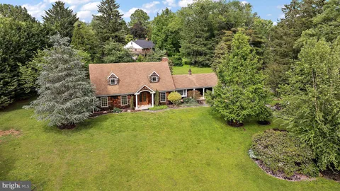 a view of a house with pool and a yard