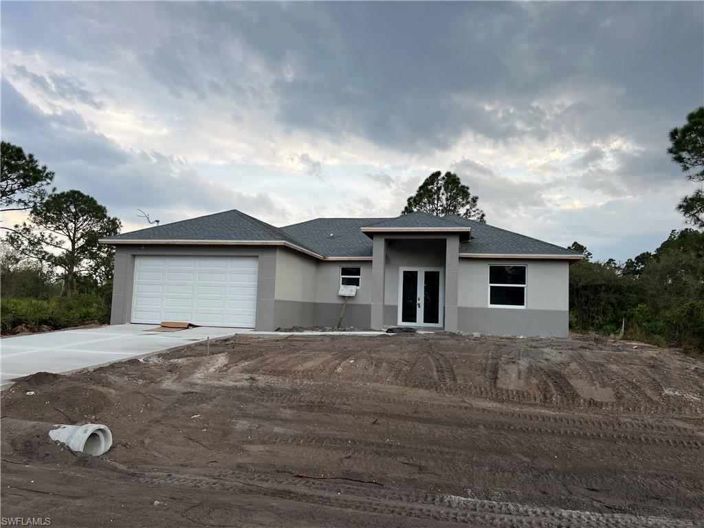 335 Ranch Avenue Lehigh Acres, FL 33974 - Photo 1 of 24 a view of a house with a yard