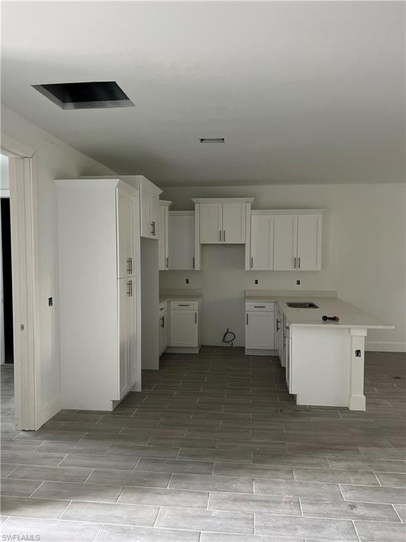335 Ranch Avenue Lehigh Acres, FL 33974 - Photo 17 of 24 a kitchen with a refrigerator and white cabinets