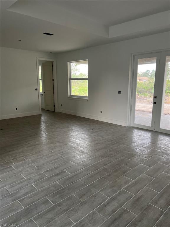 335 Ranch Avenue Lehigh Acres, FL 33974 - Photo 18 of 24 wooden floor in an empty room with a window