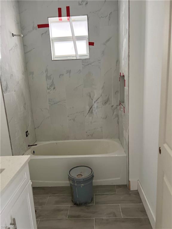 335 Ranch Avenue Lehigh Acres, FL 33974 - Photo 21 of 24 a bathroom with a shower and a bathtub