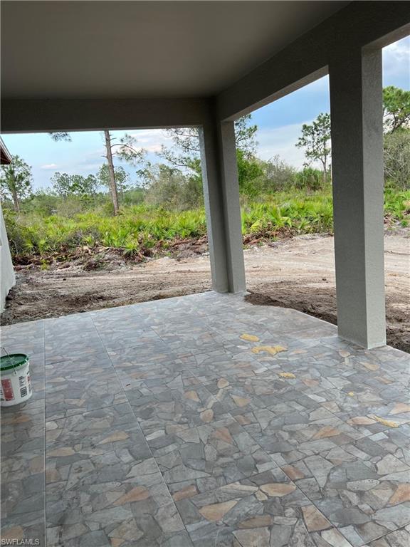 335 Ranch Avenue Lehigh Acres, FL 33974 - Photo 23 of 24 a view of a big room with floor to ceiling windows and garden