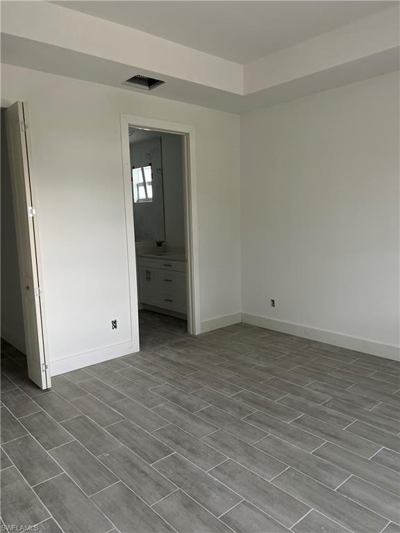 335 Ranch Avenue Lehigh Acres, FL 33974 - Photo 24 of 24 a view of empty room with wooden floor and window