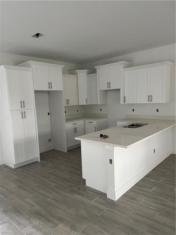 335 Ranch Avenue Lehigh Acres, FL 33974 - Photo 4 of 24 a kitchen with cabinets stove and wooden floor