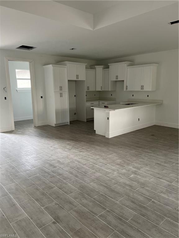 335 Ranch Avenue Lehigh Acres, FL 33974 - Photo 5 of 24 a view of a kitchen with wooden floor