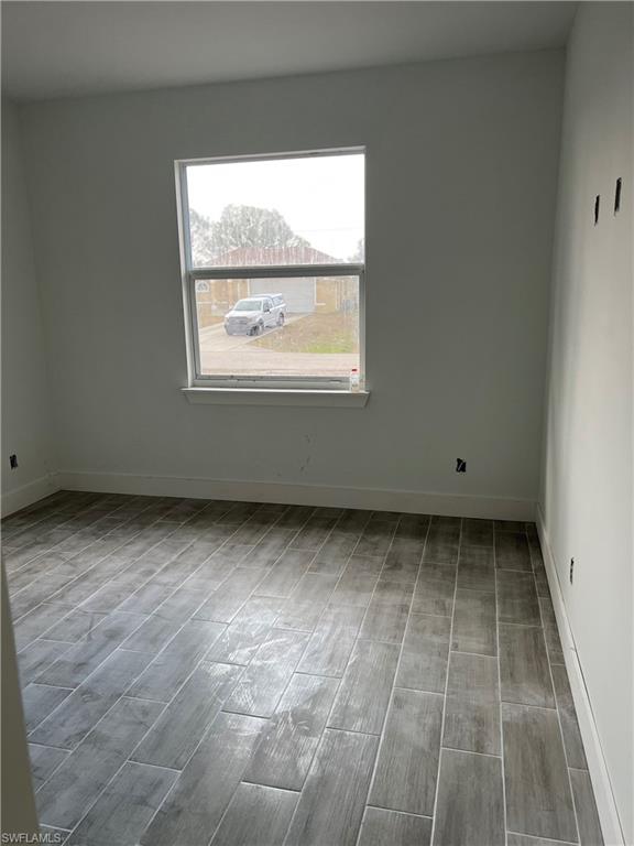 335 Ranch Avenue Lehigh Acres, FL 33974 - Photo 9 of 24 a view of an empty room with a window