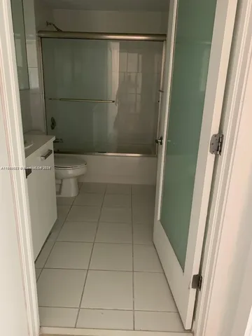 a bathroom with a shower and a toilet