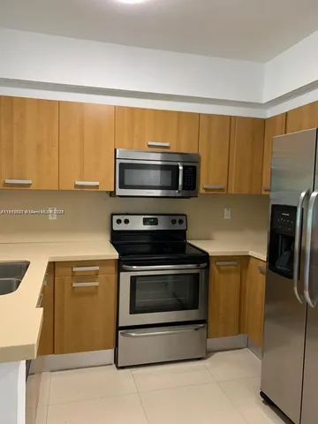a kitchen with a stove microwave and refrigerator