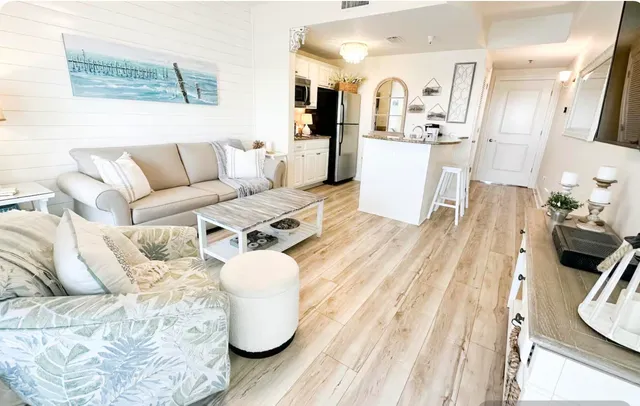 a kitchen with stainless steel appliances a microwave a stove and white cabinets