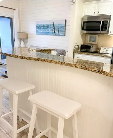 a kitchen with stainless steel appliances granite countertop a sink and cabinets
