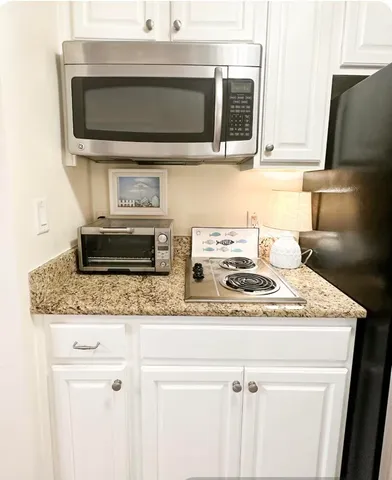 a kitchen with stainless steel appliances a refrigerator a stove a microwave and cabinets