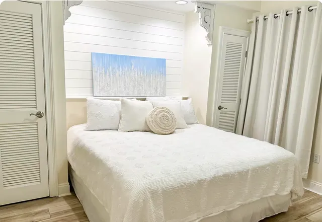 a bedroom with a bed and a painting on the wall