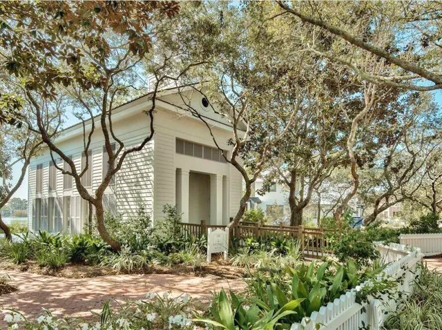 a kitchen with a table chairs and a wooden floor