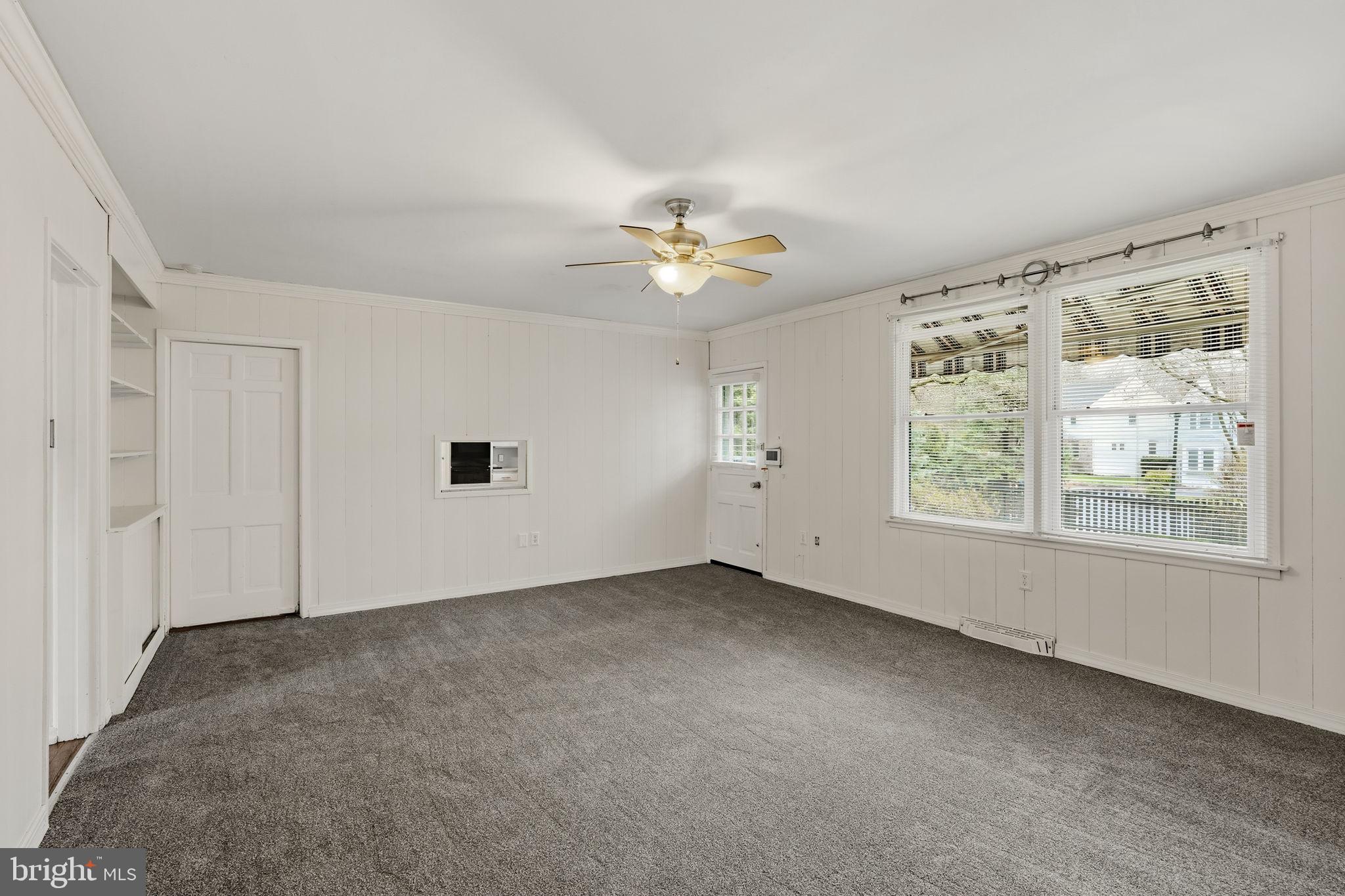 2301 Edgewood Road Harrisburg, PA 17104 - Photo 11 of 63 an empty room with chandelier fan and windows