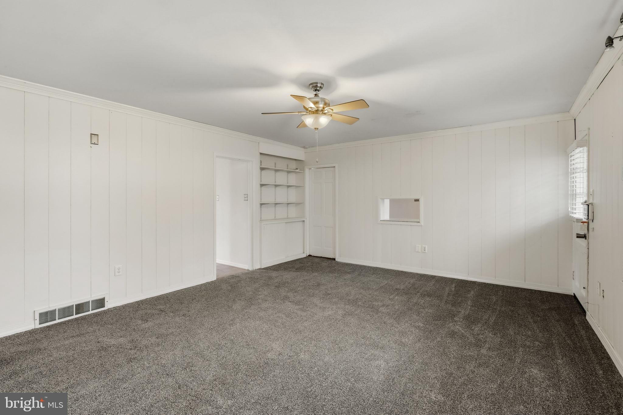 2301 Edgewood Road Harrisburg, PA 17104 - Photo 10 of 63 an empty room with chandelier fan and windows
