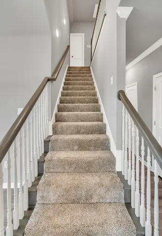 a view of a hallway with wooden floor and entryway