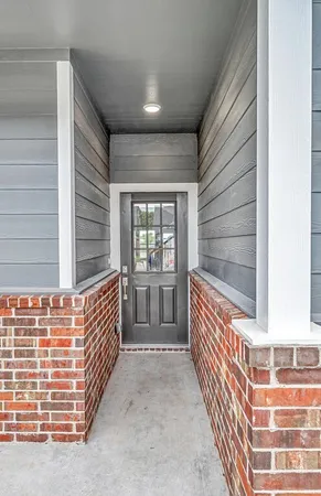 a large kitchen with stainless steel appliances a large counter top a sink a refrigerator and a wooden floors