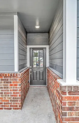 a large kitchen with stainless steel appliances a large counter top a sink a refrigerator and a wooden floors