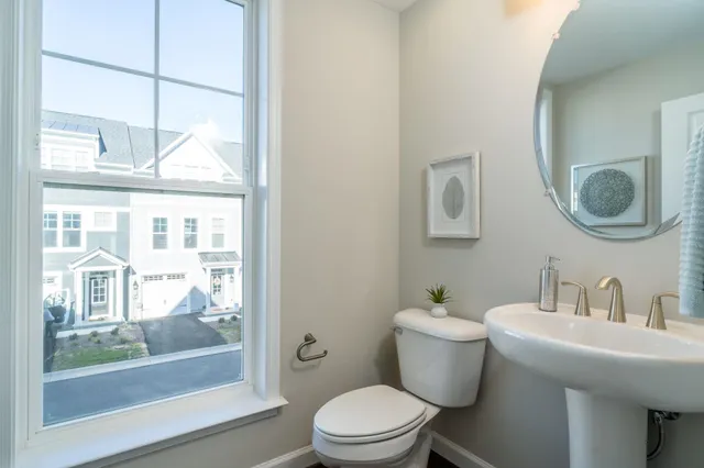a bathroom with a toilet a sink and a mirror