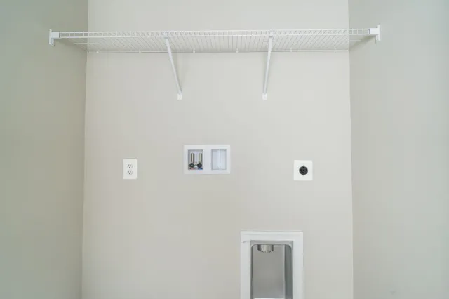 a view of a hallway with a white walls and stairs