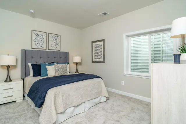 a bathroom with a granite countertop sink toilet a mirror and shower