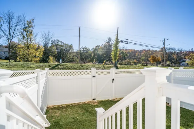 a view of a house with backyard and porch