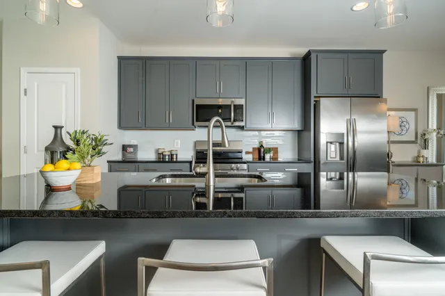 a kitchen with stainless steel appliances a sink a stove and a refrigerator