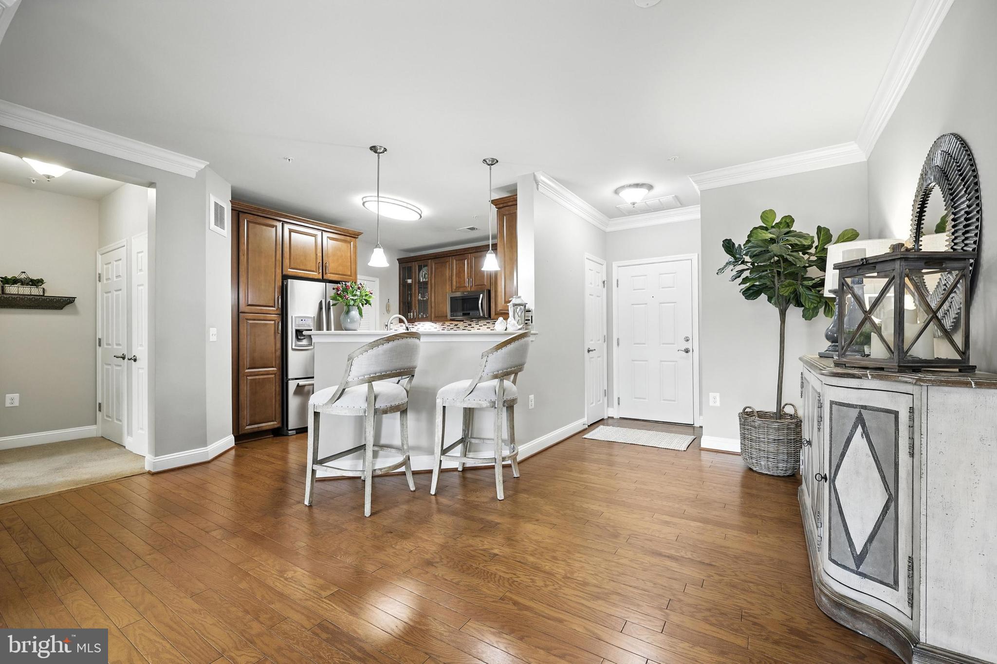 3910 Doc Berlin Drive, Unit 21 Silver Spring, MD 20906 - Photo 12 of 27 a view of a livingroom with furniture a flat screen tv and wooden floor