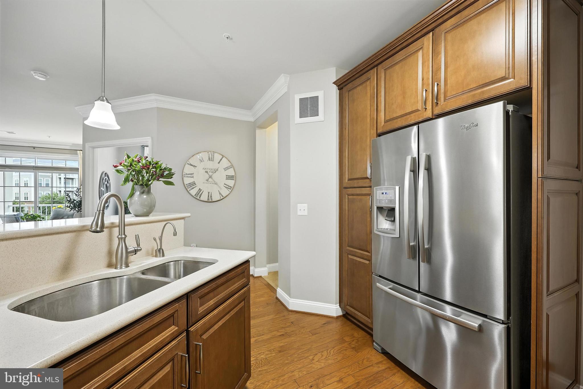 3910 Doc Berlin Drive, Unit 21 Silver Spring, MD 20906 - Photo 15 of 27 a kitchen with stainless steel appliances granite countertop a refrigerator a sink and a sink
