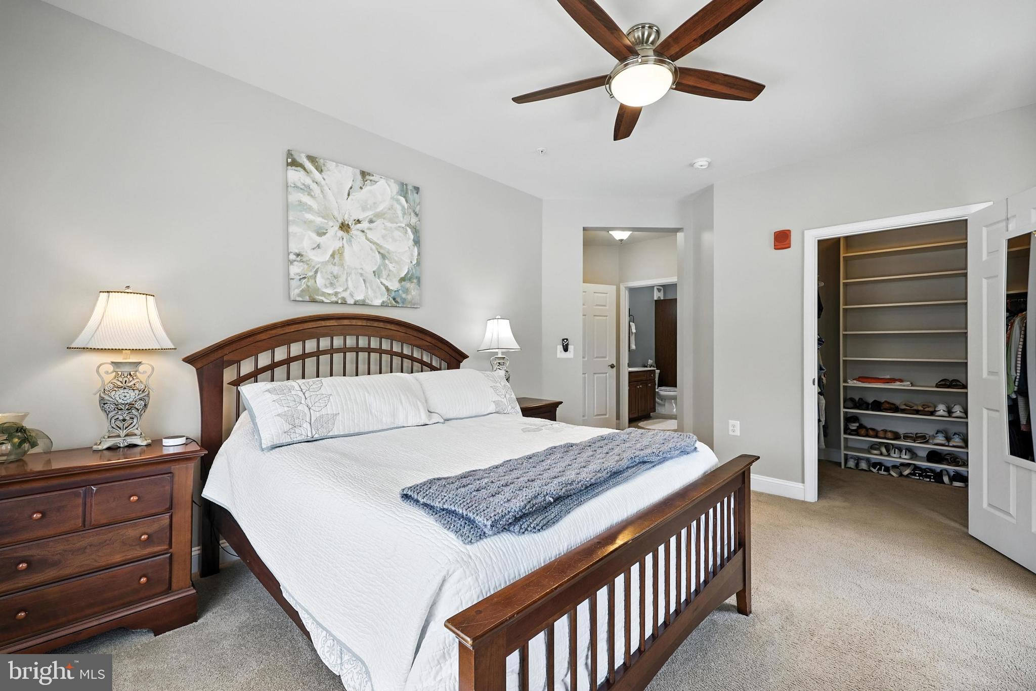 3910 Doc Berlin Drive, Unit 21 Silver Spring, MD 20906 - Photo 20 of 27 a bedroom with a bed and a chandelier