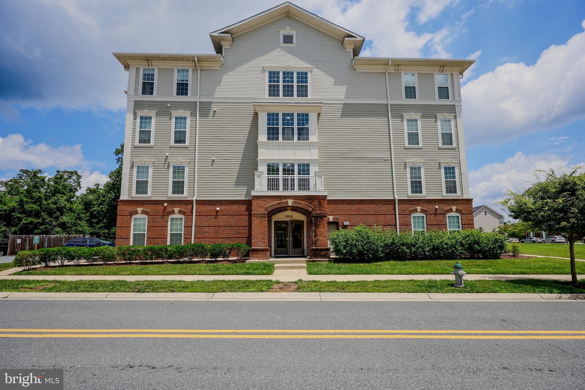 3910 Doc Berlin Drive, Unit 21 Silver Spring, MD 20906 - Photo 2 of 27 a front view of a building and a yard