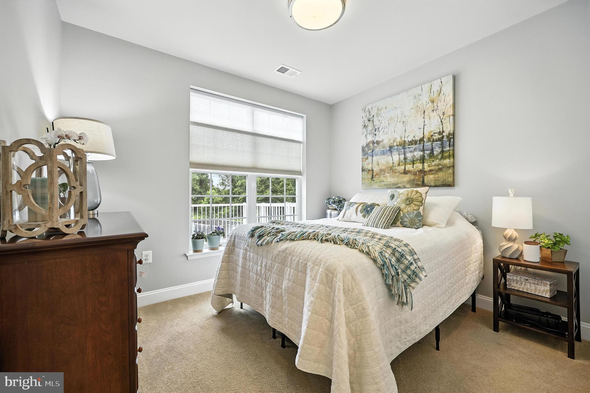 3910 Doc Berlin Drive, Unit 21 Silver Spring, MD 20906 - Photo 23 of 27 a bed sitting in a bedroom next to a window