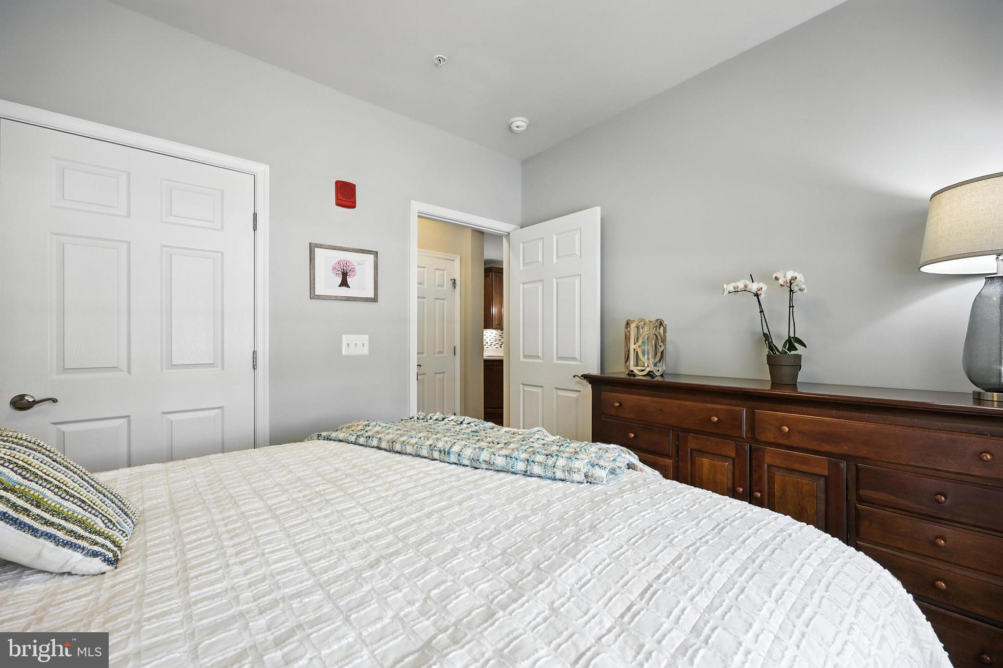 3910 Doc Berlin Drive, Unit 21 Silver Spring, MD 20906 - Photo 24 of 27 a bedroom with a large bed and a dresser
